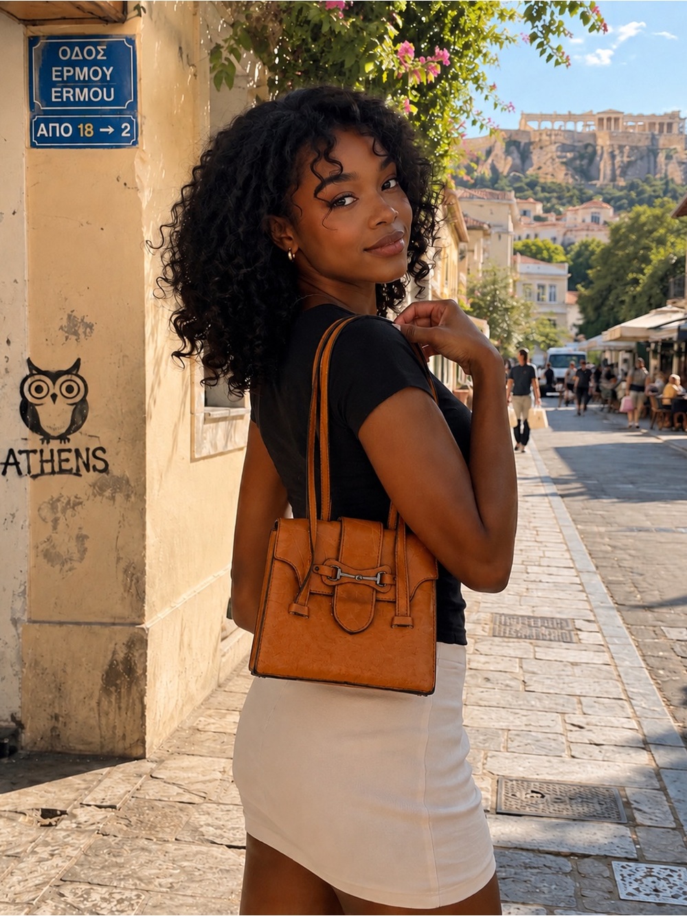 Margolin tan leather handbag features a structured rectangular  and a top handle